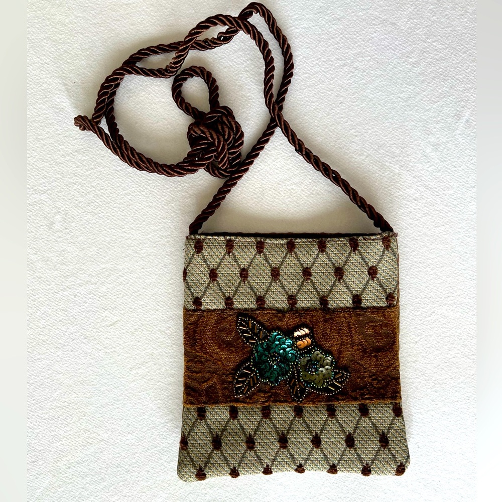 Handcrafted crossbody shoulder bag made from assorted fabrics and sequin trim.